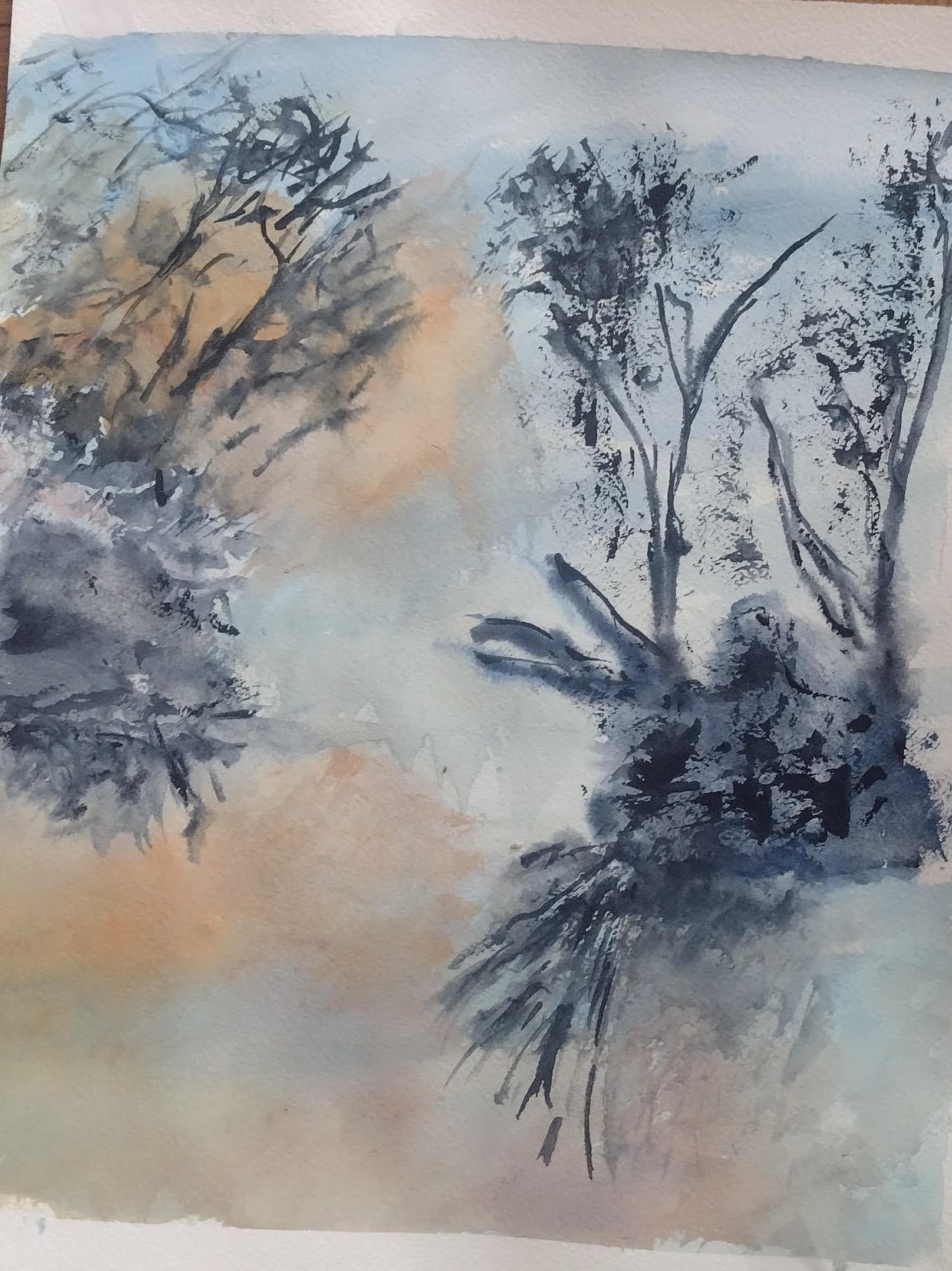 Impressionistic watercolor of dark trees silhouetted against a soft, hazy blue and orange background.